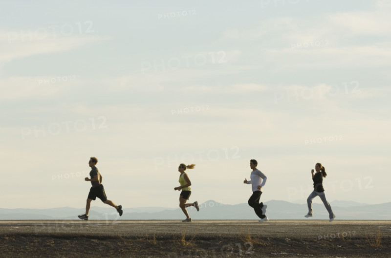 Group of people running on road, Utah, United States. Date : 2007