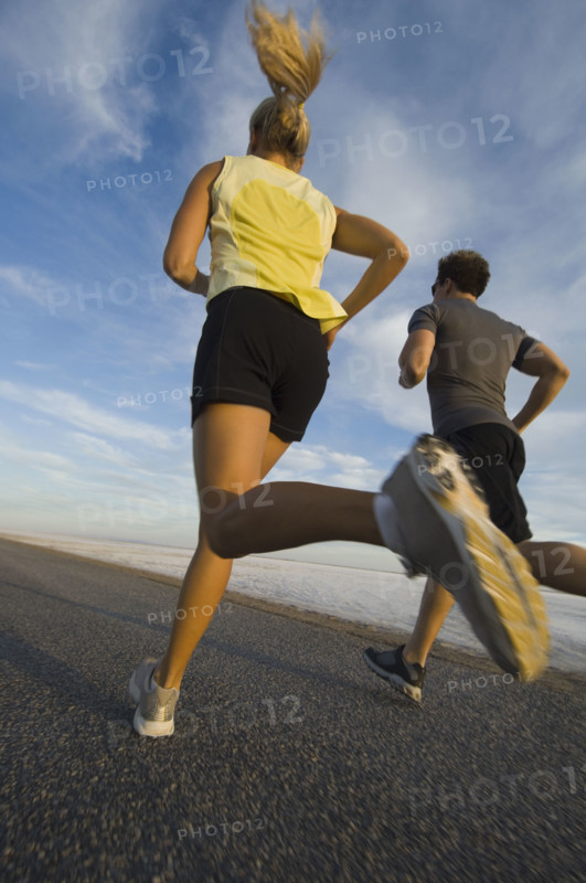 Couple running on road, Utah, United States. Date : 2007