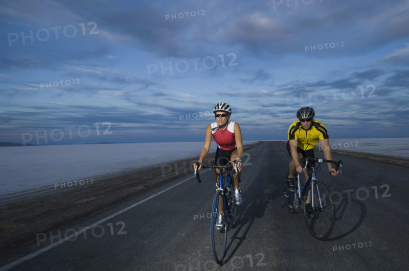 Couple cycling on road, Utah, United States. Date : 2007