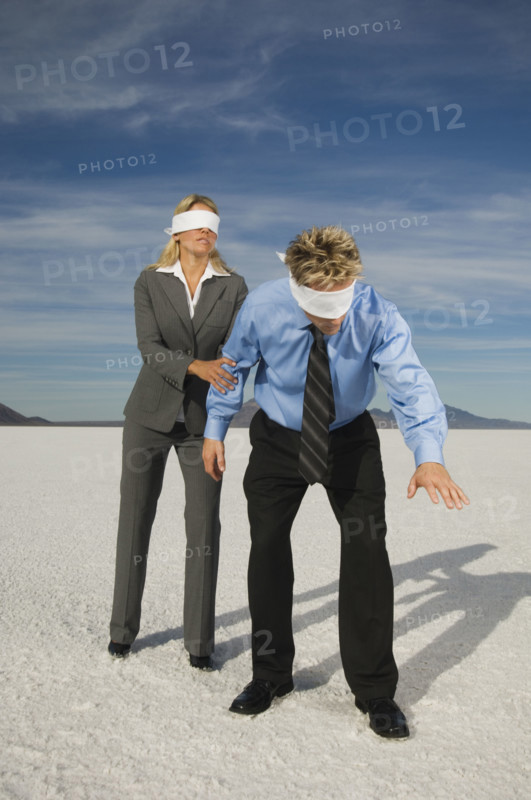 Blindfolded businesspeople on salt flats, Salt Flats, Utah, United States. Date : 2007