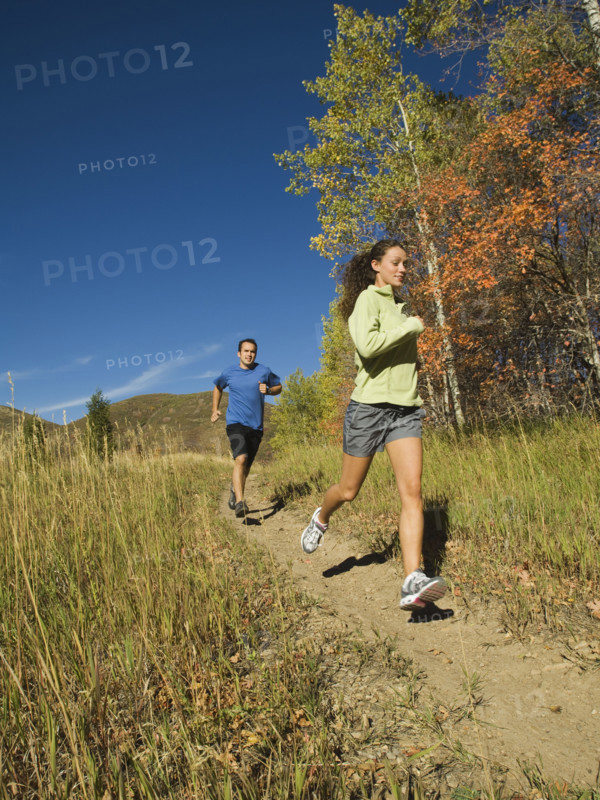Couple jogging on trail, Utah, United States. Date : 2007