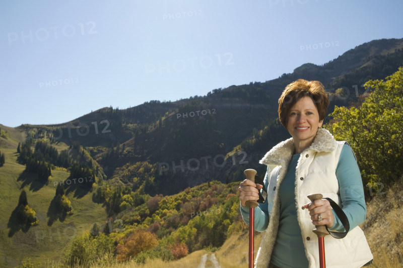 Senior woman holding hiking poles, Utah, United States. Date : 2007