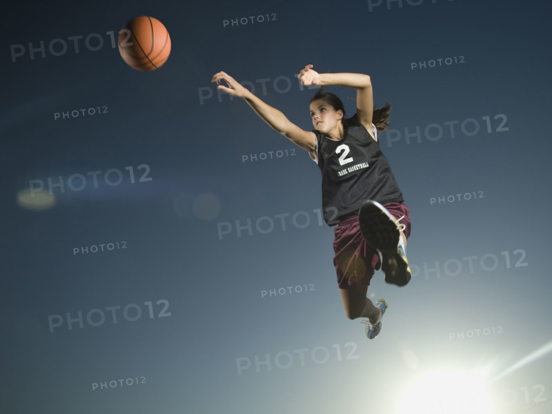 Girl jumping with basketball. Date : 2007
