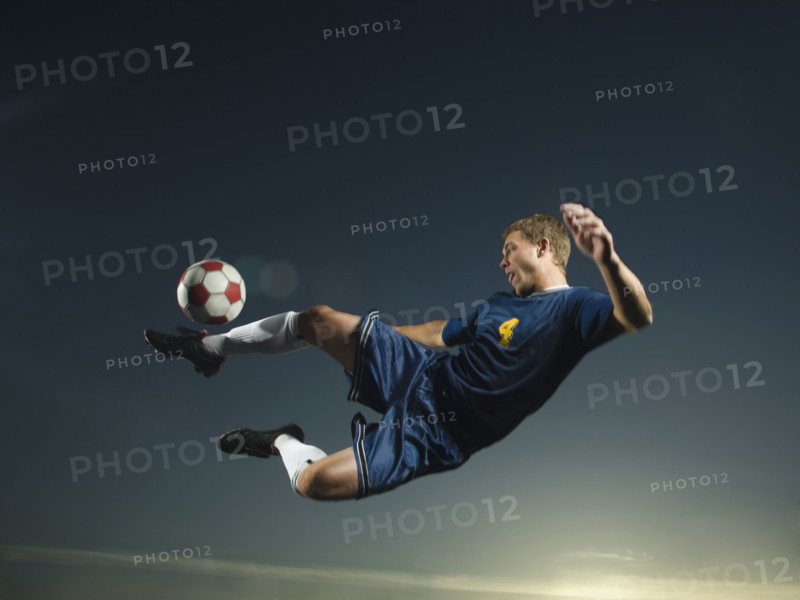 Man kicking soccer ball in air. Date : 2007