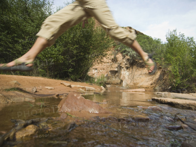 Woman jumping over stream. Date : 2007