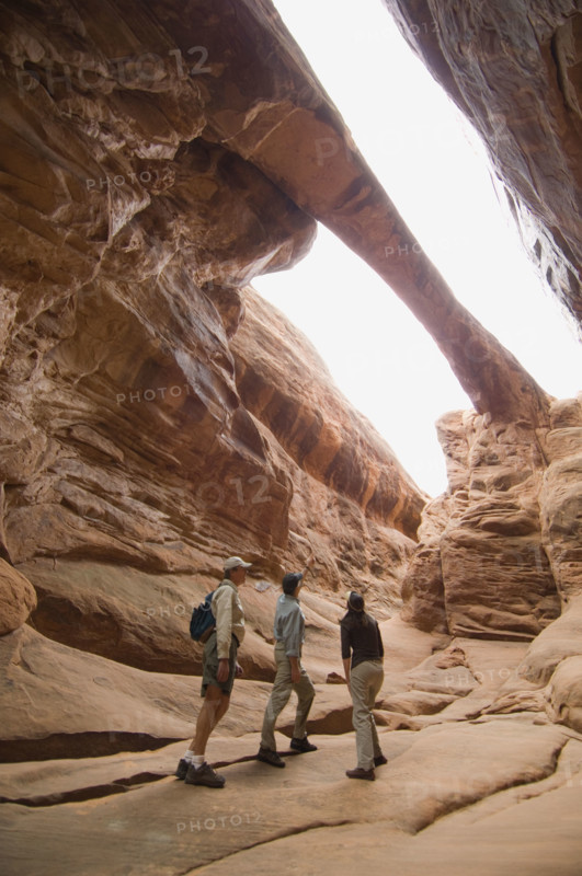 People looking up at rock formations. Date : 2007