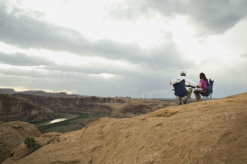 Couple in camping chairs over-looking canyon. Date : 2007