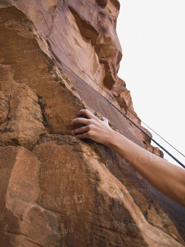 Close up of woman’s arm rock climbing. Date : 2007
