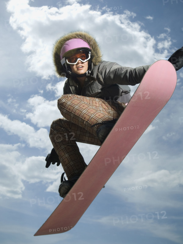 Low angle view of snowboarder jumping. Date : 2007