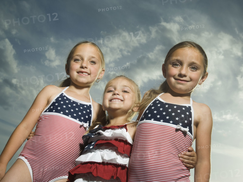 Three young sisters hugging. Date : 2007