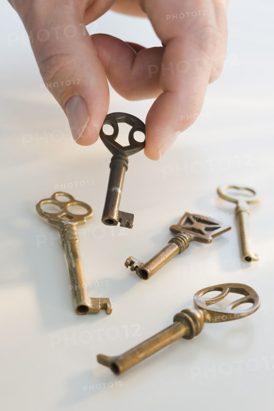 Man picking up old fashioned key.