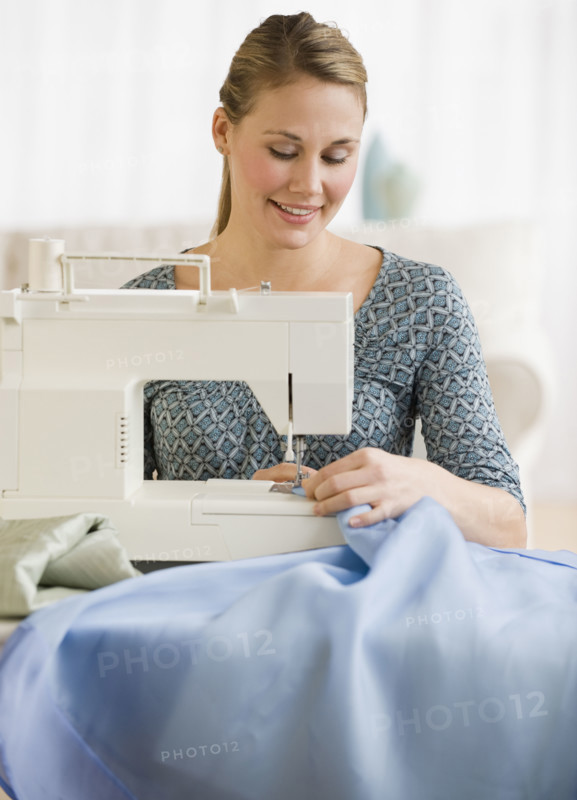 Woman using sewing machine.