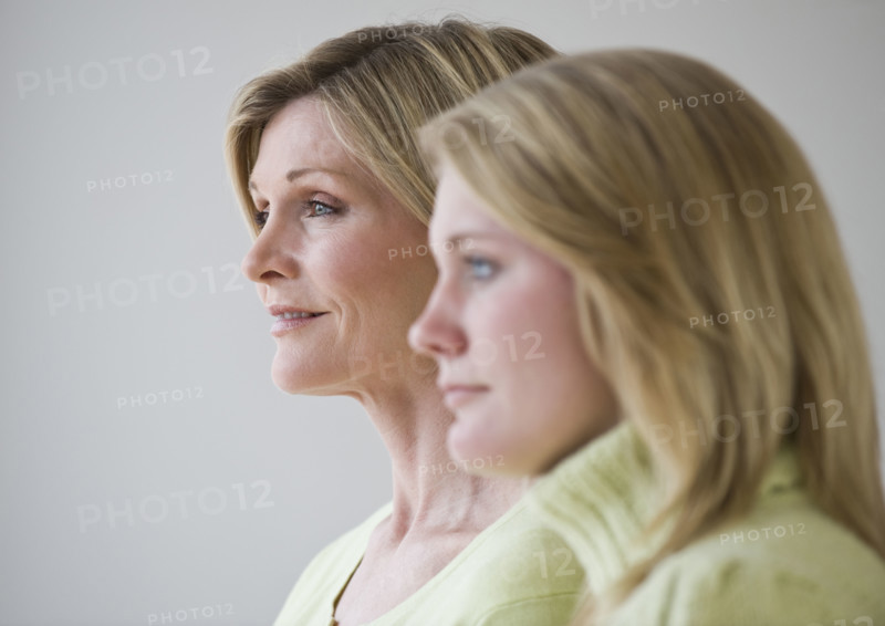 Mother and daughter standing next to each other.