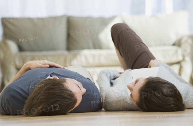 Couple laying on floor.