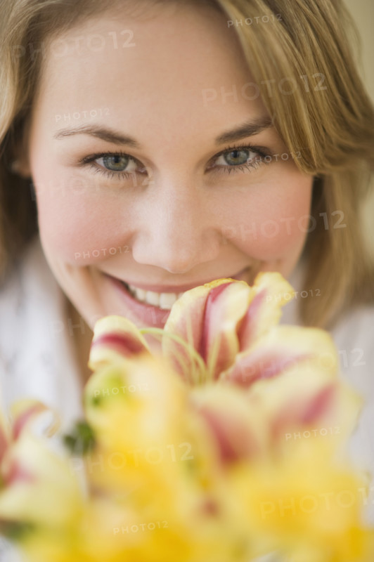 Woman smelling flower.