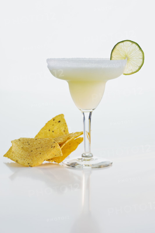 Margarita next to tortilla chips.
