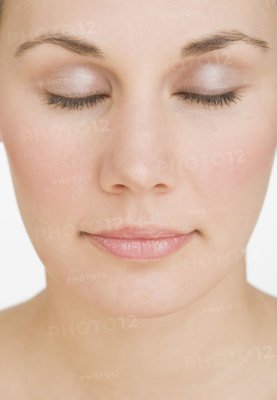 Close up of woman with eyes closed.