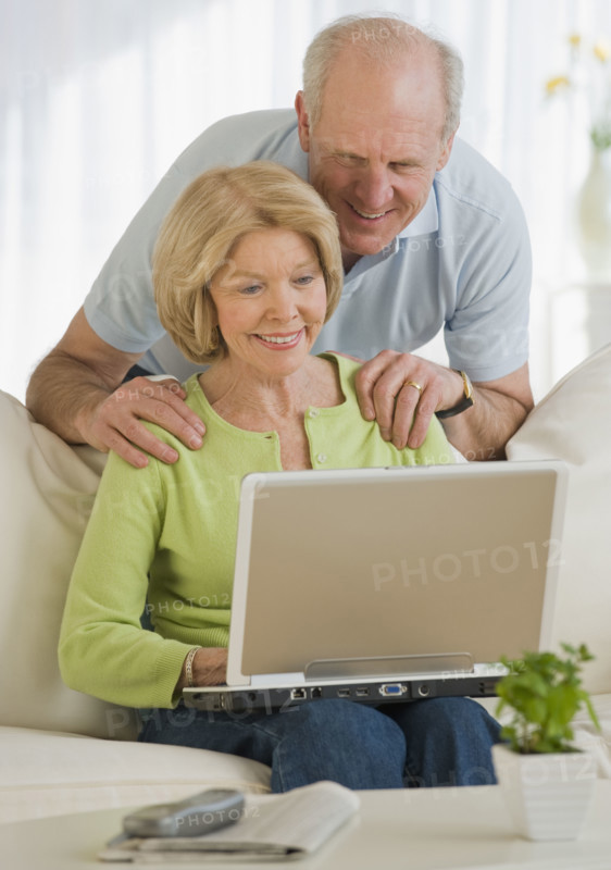Senior couple looking at laptop.
