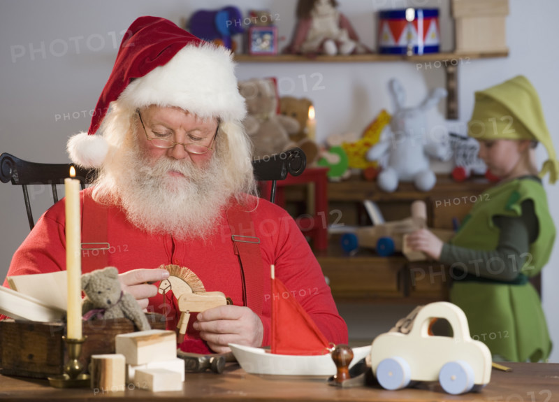 Santa Claus looking at toys.