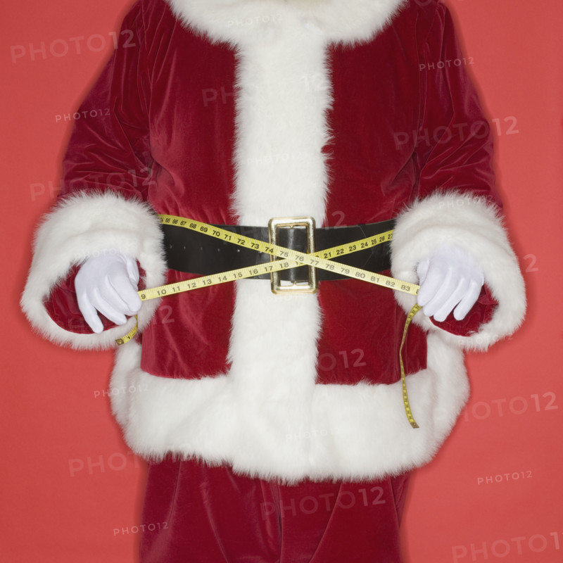 Santa Claus measuring waist with tape measure.