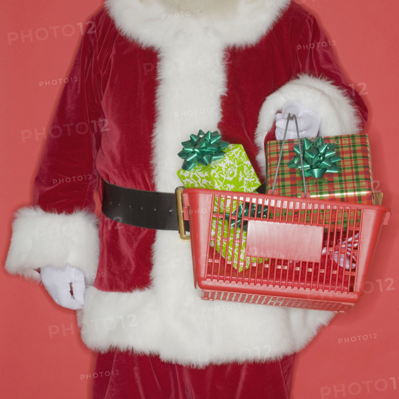Santa Claus holding shopping basket with gifts.