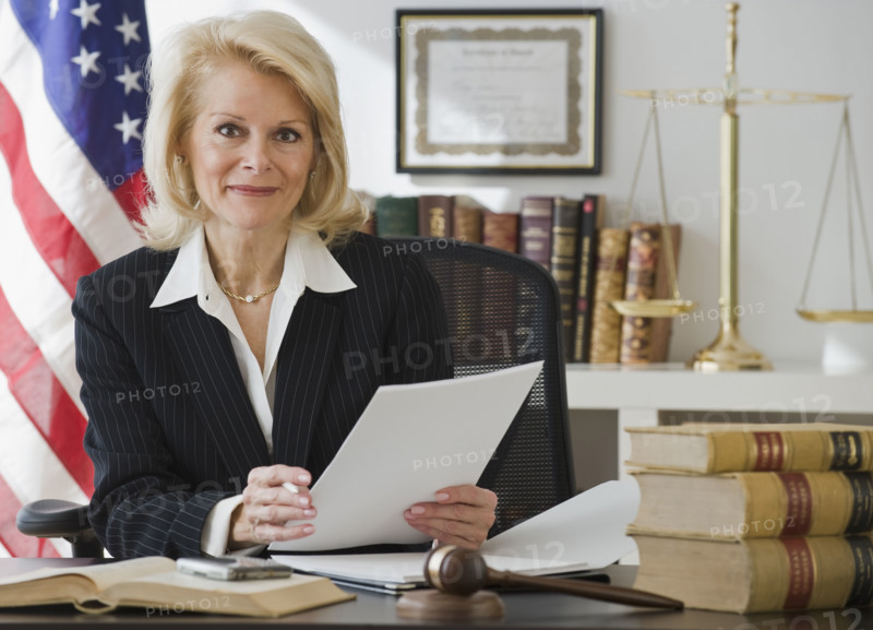 Businesswoman holding paperwork.
