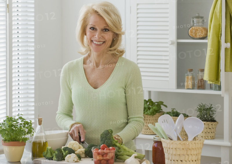 Senior woman chopping vegetables.