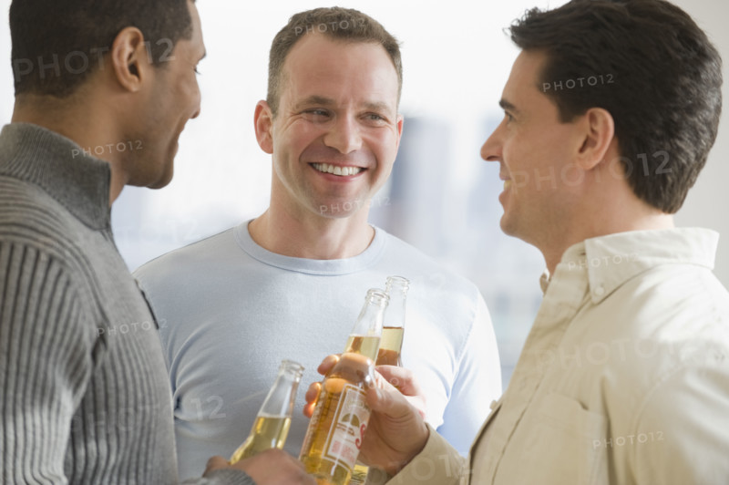 Multi-ethnic men drinking beer.