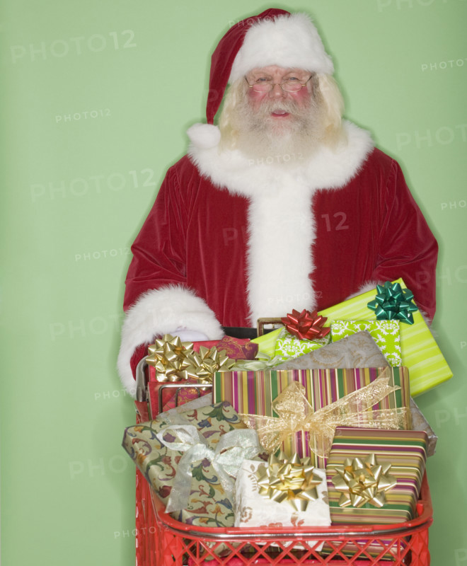 Santa Claus pushing shopping cart of gifts.