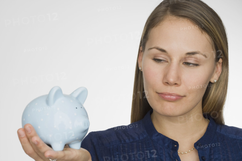 Woman holding piggy bank.