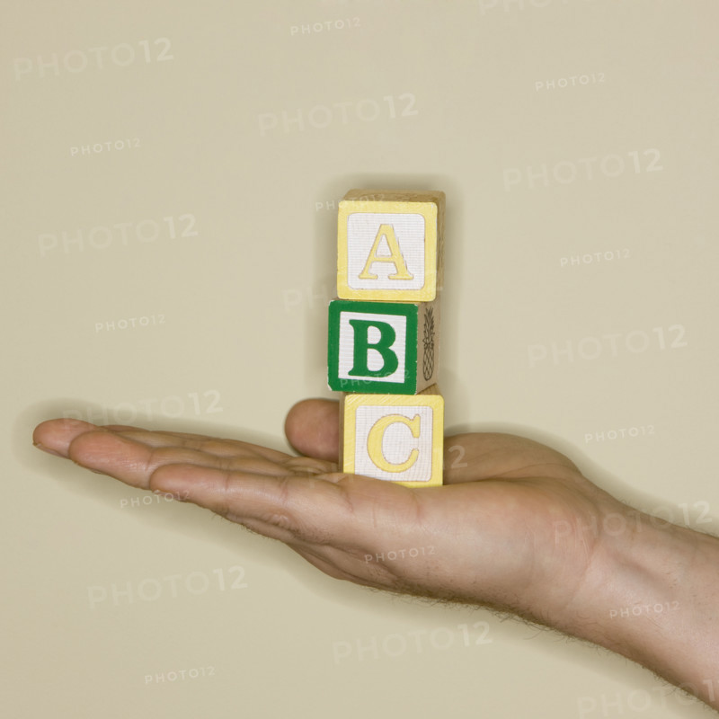 Man holding ABC blocks.