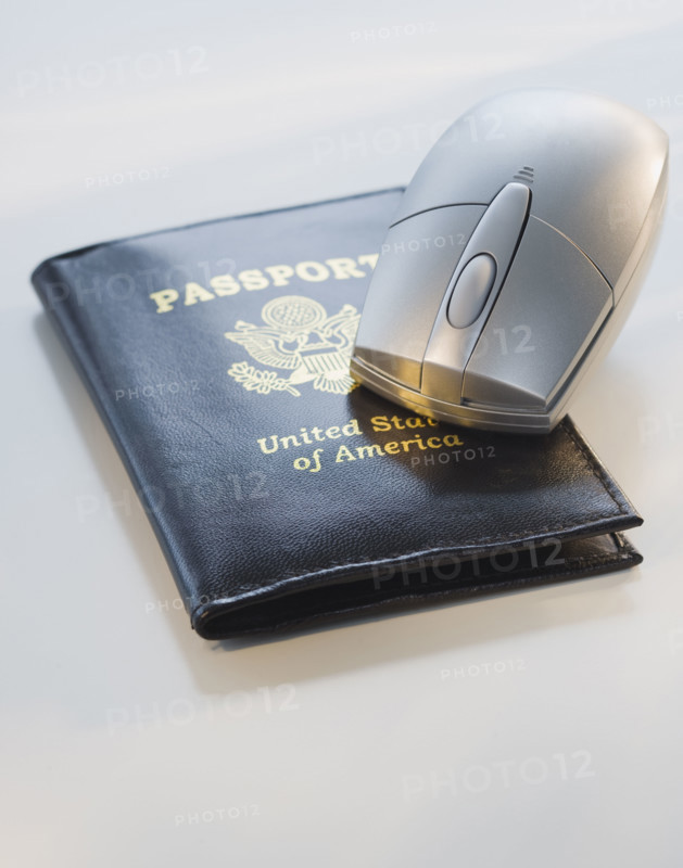 Computer mouse on passport.