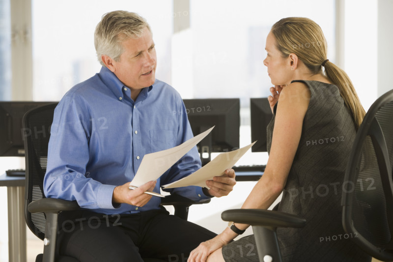 Businessman and businesswoman talking.