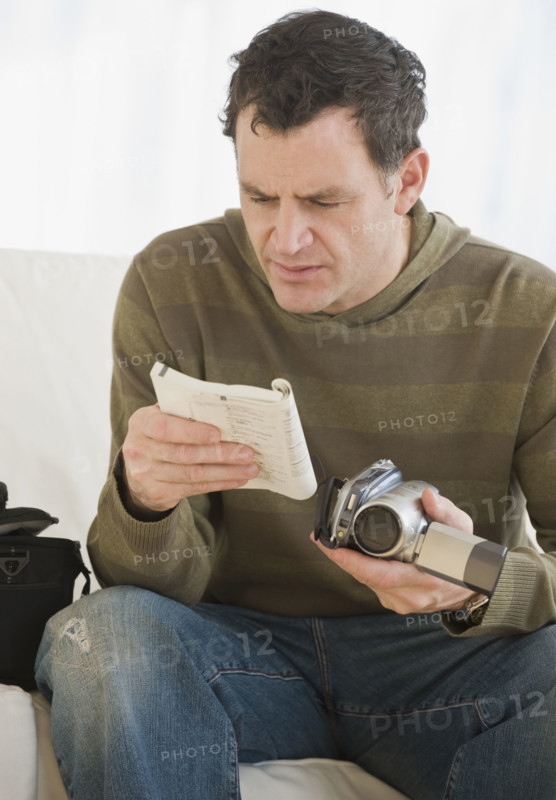 Man reading camera manual.