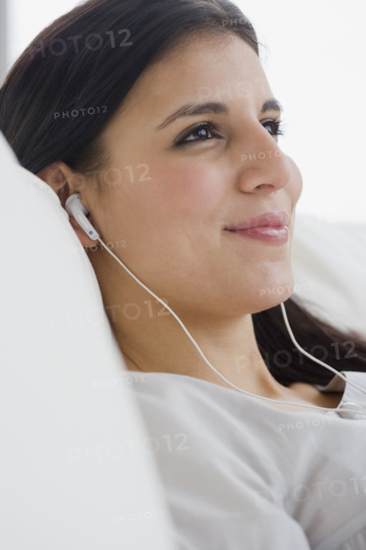 Woman listening to mp3 player.
