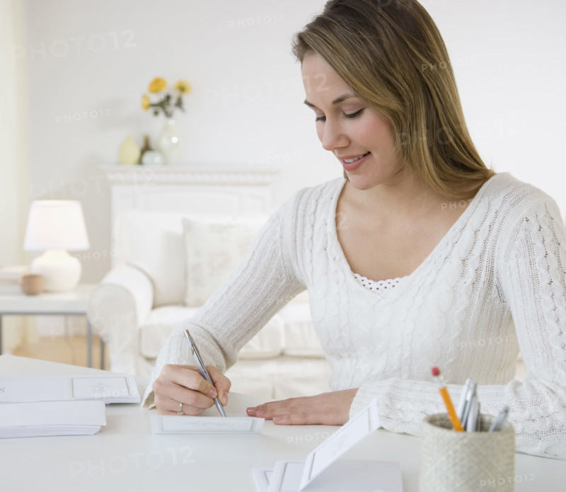 Woman writing at desk.