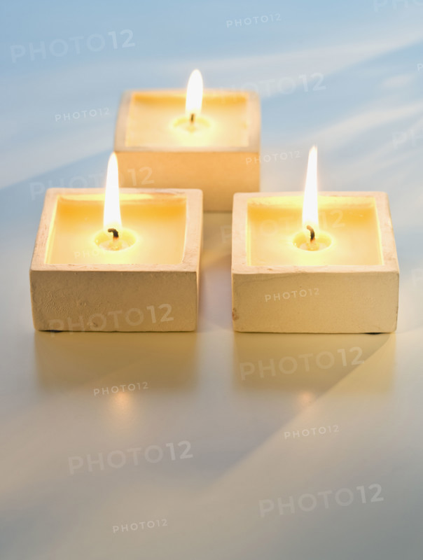 Close up of lit candles.