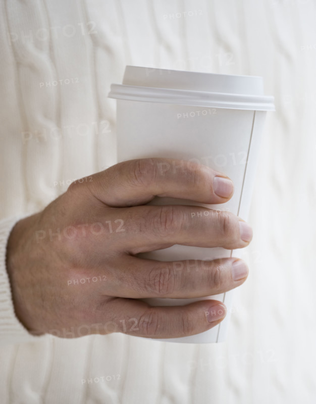 Close up of man holding take out coffee.