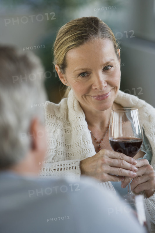 Woman holding glass of wine.