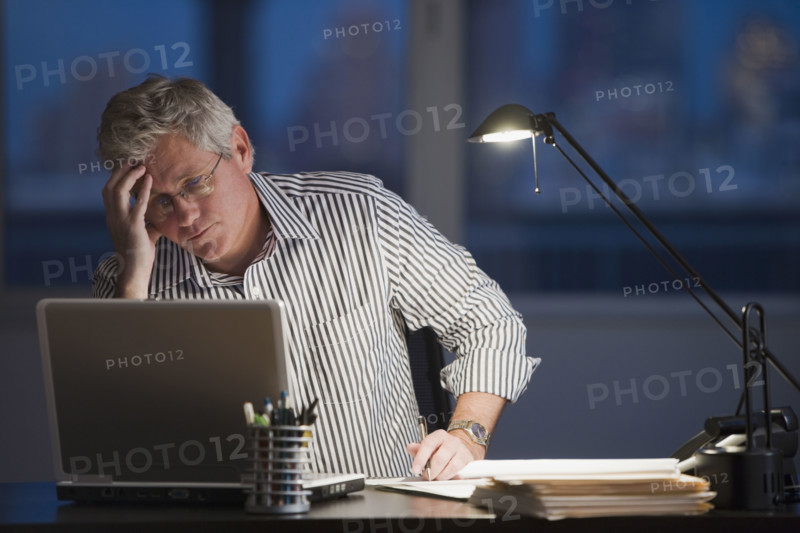 Businessman looking at laptop.