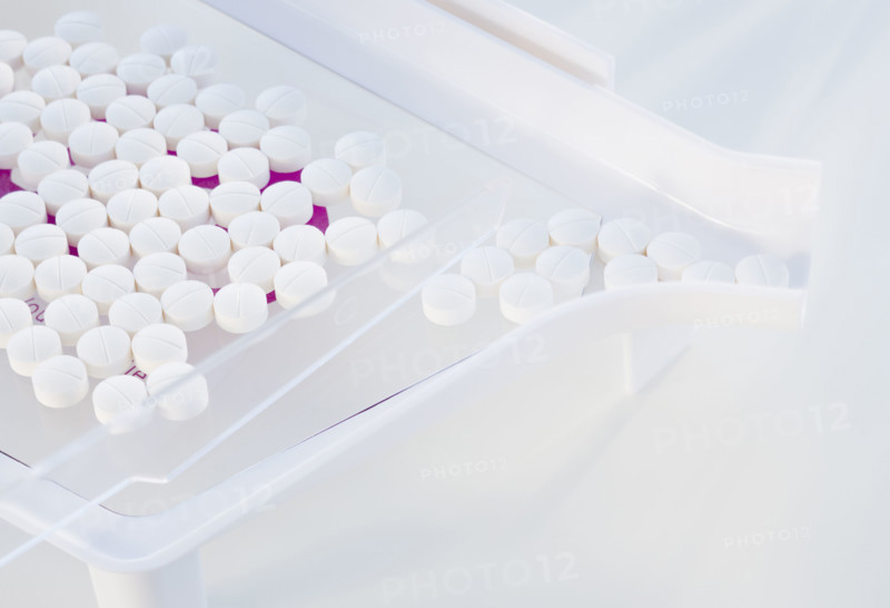 Close up of pills in measuring device.