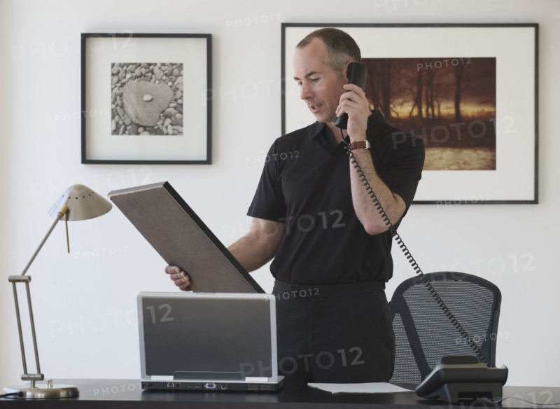 Businessman talking on telephone.