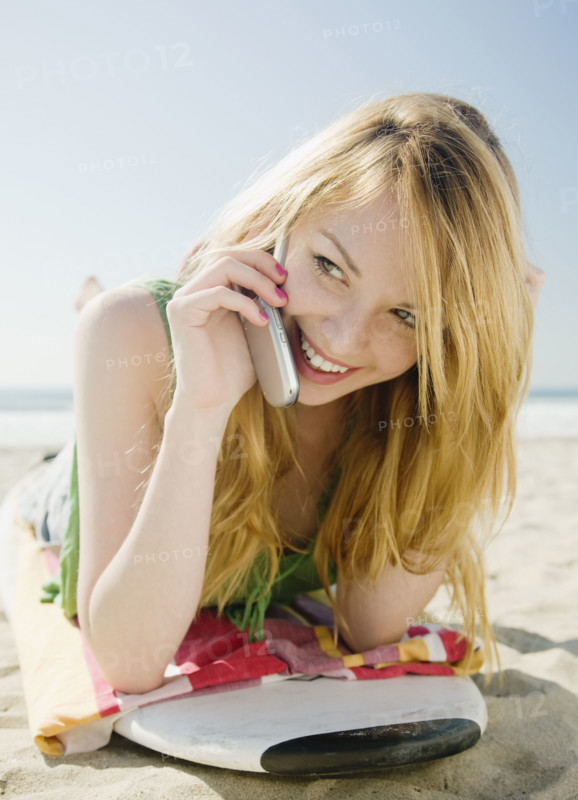 Woman talking on cell phone at beach. Date : 2008