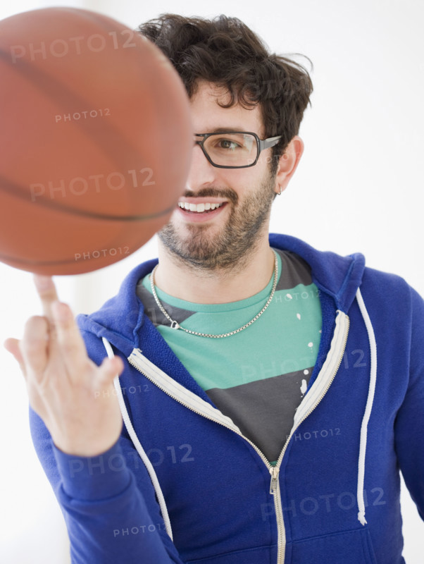 Man spinning basketball on finger. Date : 2008