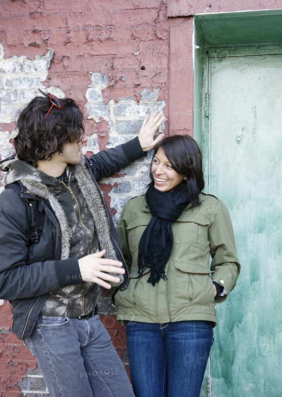 Couple talking in urban doorway. Date : 2008