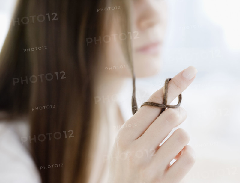 Woman with hair wrapped around finger. Date : 2008