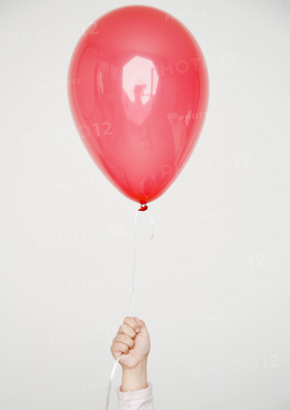 Child holding red balloon. Date : 2008