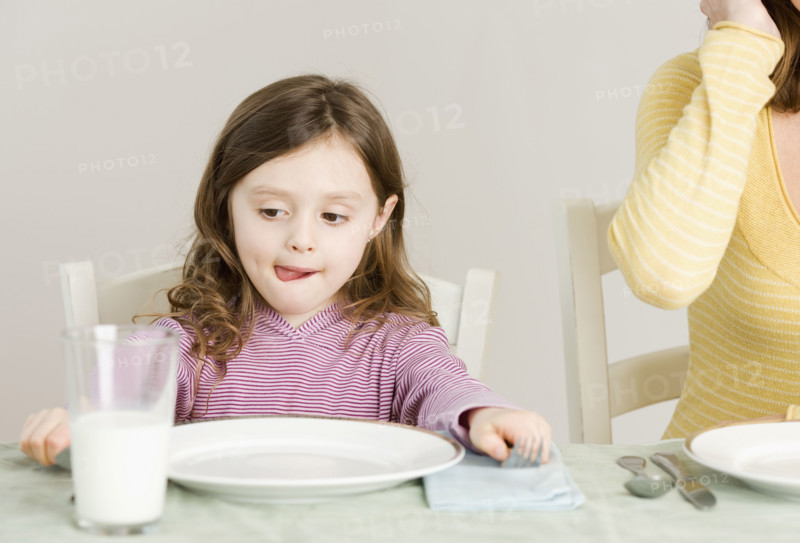 Girl sitting at dinner table. Date : 2008