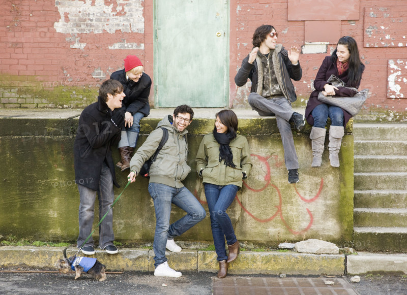 Group of friends sitting in urban scene. Date : 2008