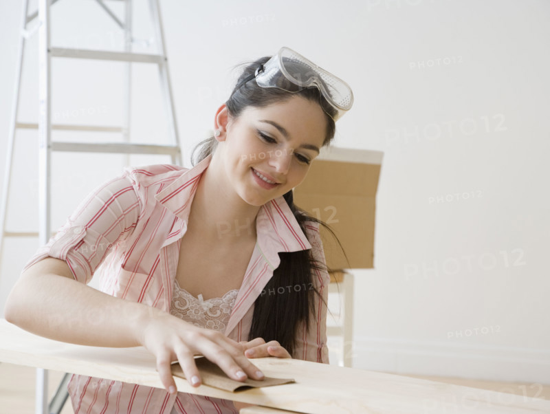 Woman sanding piece of wood. Date : 2008